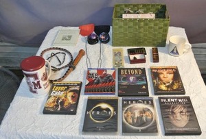 lot 117 image: Leather whip, DVDs, wall decor, Arrowhead, space shuttle coffee cup and massaging tools more see pictures