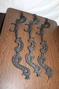 lot 297 image: Wrought iron table lags with faces on them