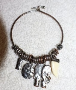 lot 137 image: Jewelry, animal themed elephant and tooth charm bracelet
