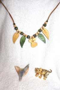 lot 151 image: Jewelry, animal themed wood koala bear necklace, carved wolf head, and tiger pin