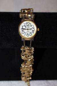 lot 170 image: Jewelry, animal themed cat bracelet watch with mother of pearl face