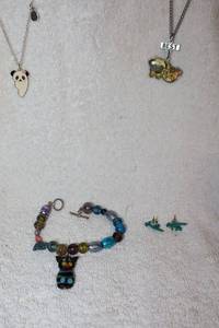 lot 119 image: Jewelry, animal themed BFF necklaces, dino earrings, and cat and bead bracelet
