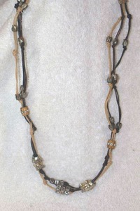 lot 131 image: Jewelry, animal themed Multistrand necklace with elephant beads and stephanie letters