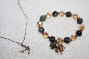 lot 103 image: Jewelry, animal themed Elephant charm and bead bracelet, and bird pendant necklace