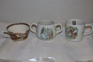 lot 180 image: WEDGWOOD Beatrix Potter mugs and brown and white tea cup