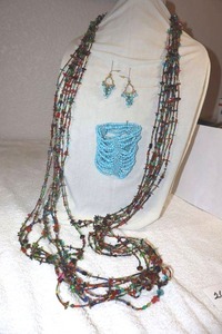 lot 260 image: Glass bead jewelry One opera length multi strand necklace, light blue stretch bracelet and matching earrings