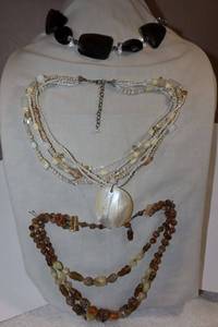 lot 243 image: Glass bead jewelry Black choker style necklace, Multi strand white shell necklace, and brown multi strand necklace