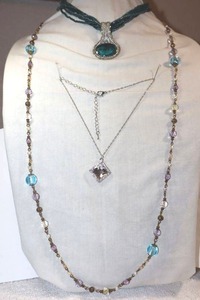 lot 244 image: Glass bead jewelry bluegreen multi strand with pendant necklace, Clear diamond shaped pendant necklace, and bluelavenderclear bead necklace