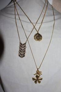 lot 33 image: Movement Jewelry gold tone necklaces with sunflower pendant necklace that opens