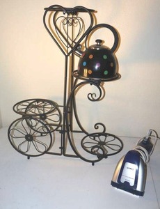 lot 318 image: black iron plant stand, metal teapot, and Conair steamer