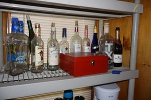 lot 337 image: Empty liquor bottles plus red storage box