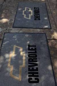 lot 440 image: Two rubber backed Chevrolet floor mats. Each are Approx. 3ft. x 4ft.