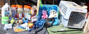 lot 443 image: Pet lot small pet crate and pet care items, shampoo, food dishes, toys, leash, floor cleaners