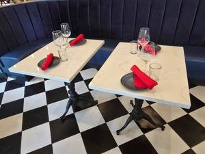 lot 59 image: Lot of 2 Tables.  Includes 2 Solid Marble Tables w Cast Iron Spindle Base &amp 4 Complete Place Settings.&nbsp Tables Measures 30 x 24