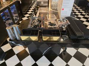 lot 106 image: Lot of Misc Bar Supplies.  Includes Shakers, Napkin Caddies, Pour Spouts, Bar Jiggers, Bar Mats & Much More