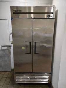 lot 35 image: True T-Series Solid Door Reach-In Refrigerator Model T-35).  Contents not included.&nbsp UNIT ROLLS FOR EASY REMOVAL.