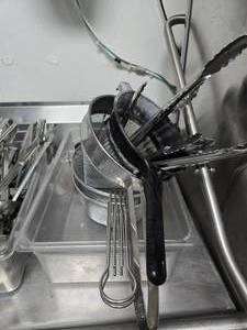 lot 135 image: Cambro Tub w Misc Tongs, Strainers & Stainless Steel Measuring Cups