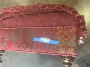 lot 59 image: RED & GOLD OTTOMAN  W ROLLERS  APPROX. 30 X30