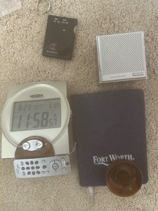 lot 169 image: Clocks and mini speaker, ring keeper, FT Worth notebook  plus more see pics