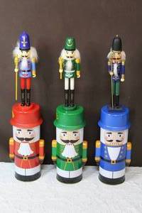 lot 63 image: Three wooden nutcrackers in nutcracker cans