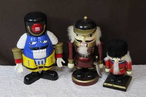 lot 65 image: Three nutcrackers one plastic two wood ones water bottle in second picture for size reference
