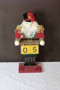 lot 152 image: This is a decorative wooden nutcracker, specifically a drummer soldier figurine. Blocks come out to change days also one of his drumsticks is broke see pictures