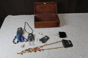 lot 187 image: Jewelry box with some fashion jewelry in it the bottom of the box needs to be fixed