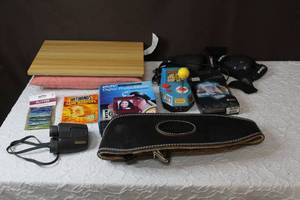 lot 225 image: Bushnell binoculars  lap board Pac-Man plug and Playdigital photo album keychainhand warmersand much more