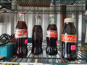 lot 90 image: Selection of collectible coke bottles