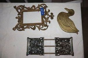 lot 34 image: BrassBronze items duck trivet, photo frame, and folding book holder