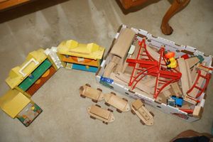 lot 13 image: Toys wood trains and train track, plus vintage Fisher Price play house as shown