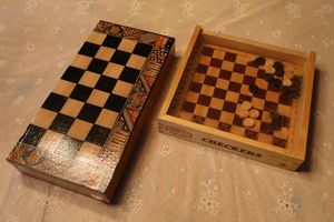 lot 71 image: Mini wooden checkers board and chess board with ceramic chess figures