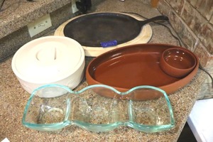 lot 159 image: Mexican food serving dishes cast iron fajita platter, oval chips and dip platter, glass condiment server and tortilla warmer