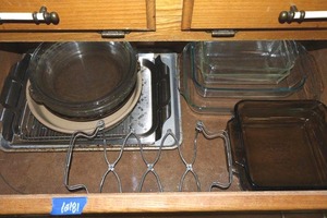 lot 181 image: Pyrex baking dishes, pie plates, stoneware plate with vintage accordion expanding trivet casserole holder