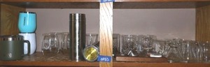 lot 183 image: Two Ion Pod water filtration cannisters, Drinking glassware, bottle openers, and insulated coffee mugs
