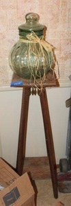 lot 145 image: Green glass jar and vintage wood plant stand