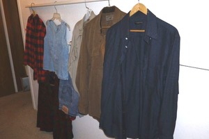 lot 243 image: Mens shirts, womens denim top, Levis jeans 36x30, and plaid shirts as shown