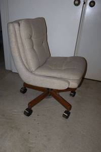 lot 236 image: Accent chair - curved seat on wheels without armrests