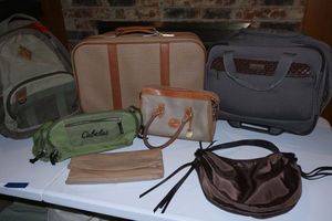lot 119 image: Luggage and purses Dooney Bourke purse, Tommy Bahama rolling case, American Tourister suitcase, Cabelas small duffle, and Denizen backpack