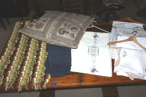 lot 123 image: Large decorative pillow, embroidered table linens, and afgan blanket