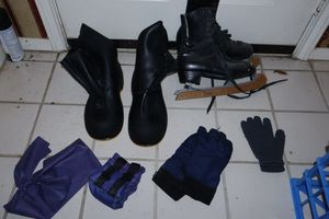 lot 131 image: Ice skates with wooden guards, SERVUS rainy day over boots, pair of ankle weights and stretch band
