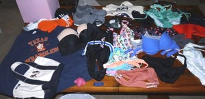 lot 154 image: Womens swimsuits, strapless bras, Athlete shoes size 7.5, and Texas Wranglers sweatshirt