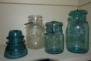 lot 205 image: Vintage Blue glass Ball jars, clear Atlas jar, and blue glass insulator Hemingray