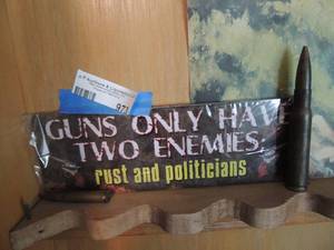 lot 973 image: sign guns only have two enemies , rust and politicians