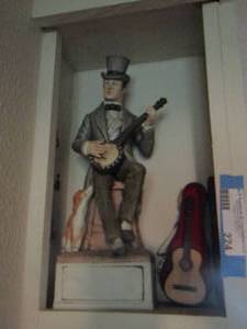 lot 224 image: man playing the banjo figurine, mini guitar