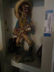 lot 226 image: statue of a man playing guitar