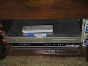lot 80 image: Magnavox dvd -vhs player with remote, various movies included