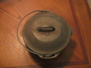 lot 297 image: cast iron sauce pan with lid