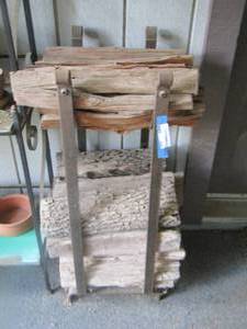 lot 449 image: wood log holder- with wood logs on it