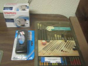 lot 654 image: staples pencil sharpener, new eraser, paint brush set